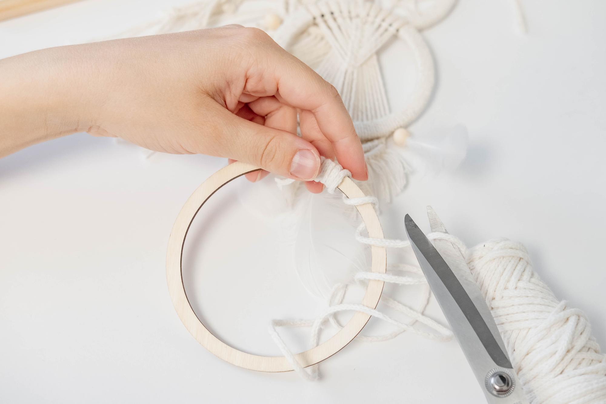 Atelier hands working on hoop