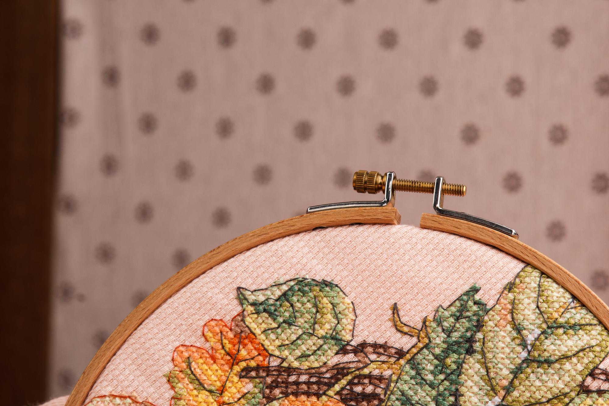 Large embroidered wall panel in muted tones